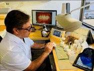 In-house laboratory technician examining completed crown