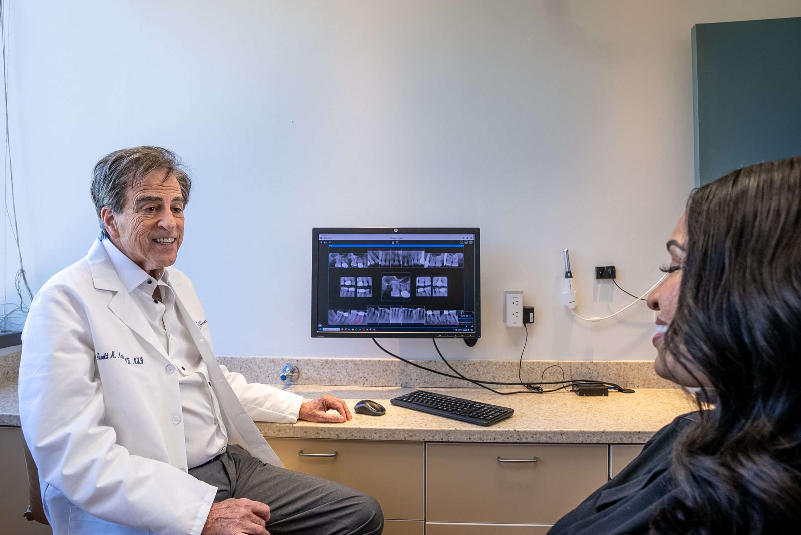 Dr. Gerald Marlin consulting with a patient at Elite Prosthetic Dentistry