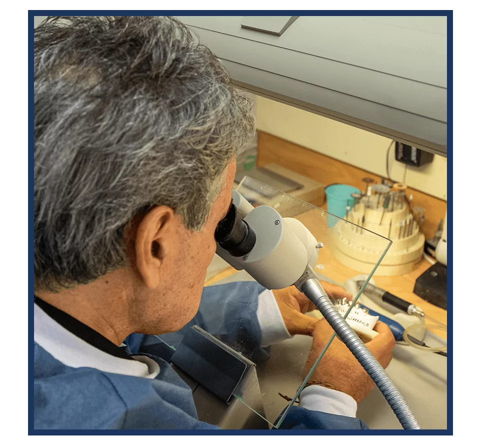 Dr. Marlin working with microscope in dental lab
